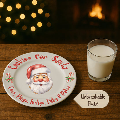 Cookies for Santa plate with a glass of milk on a wooden table with a Christmas tree and fireplace in the background.