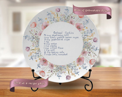 Decorative plate with floral design and recipe text on a stand, with a blurred kitchen background.