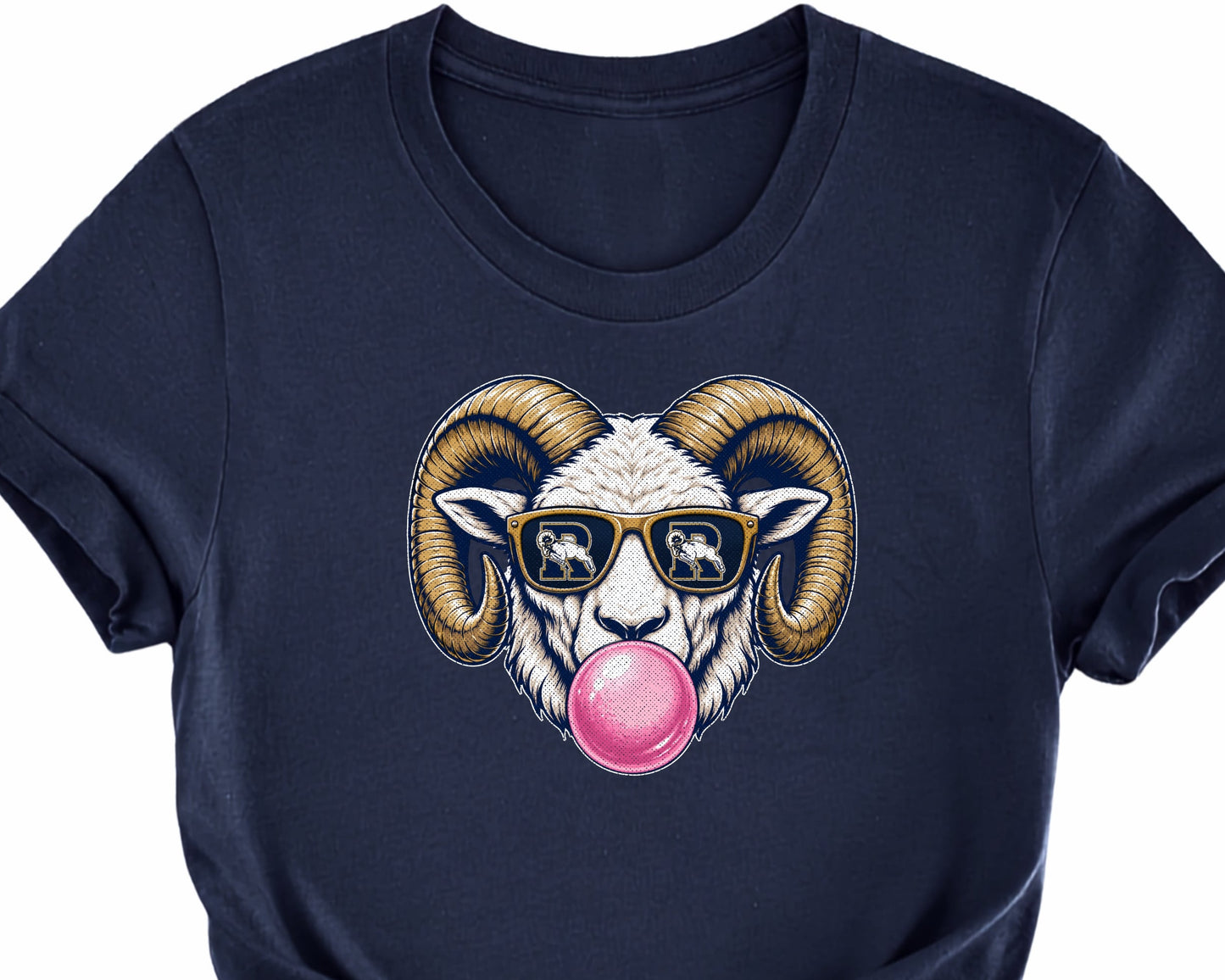 A navy blue short-sleeve t-shirt with a graphic of a ram wearing sunglasses with Ringgold's R Ram Logo in the sunglass lens, and blowing a pink bubblegum bubble, styled with a knot at the bottom hem against a white background.