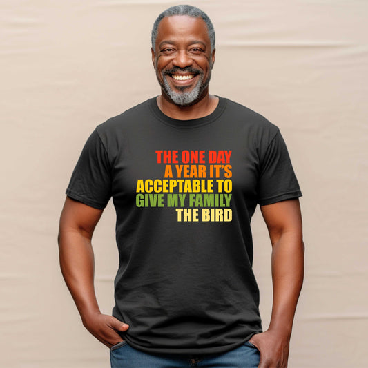 Smiling man wearing a black t with the phrase, The one day a year it&#39;s acceptable to give my family the bird, printed in fall colors