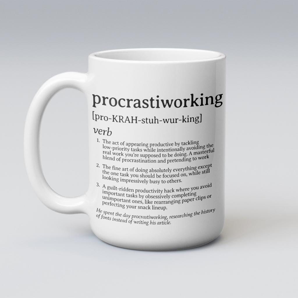 White ceramic mug reading &#39;procrastiworking&#39; definition, held against a moody blue gradient background.