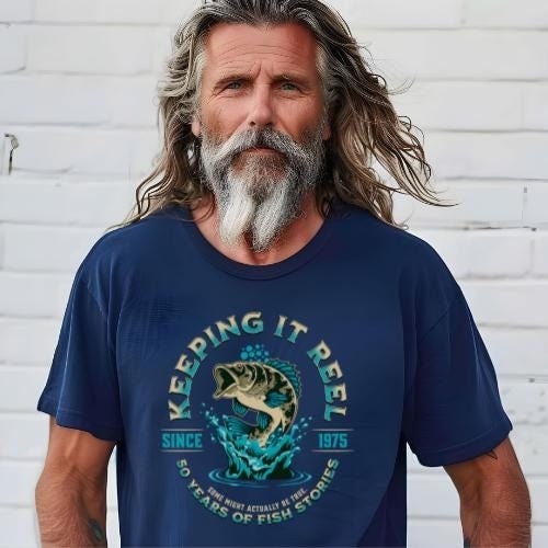 Navy Keeping It Reel – 50th Birthday shirt on a bearded man outdoors, vintage style.