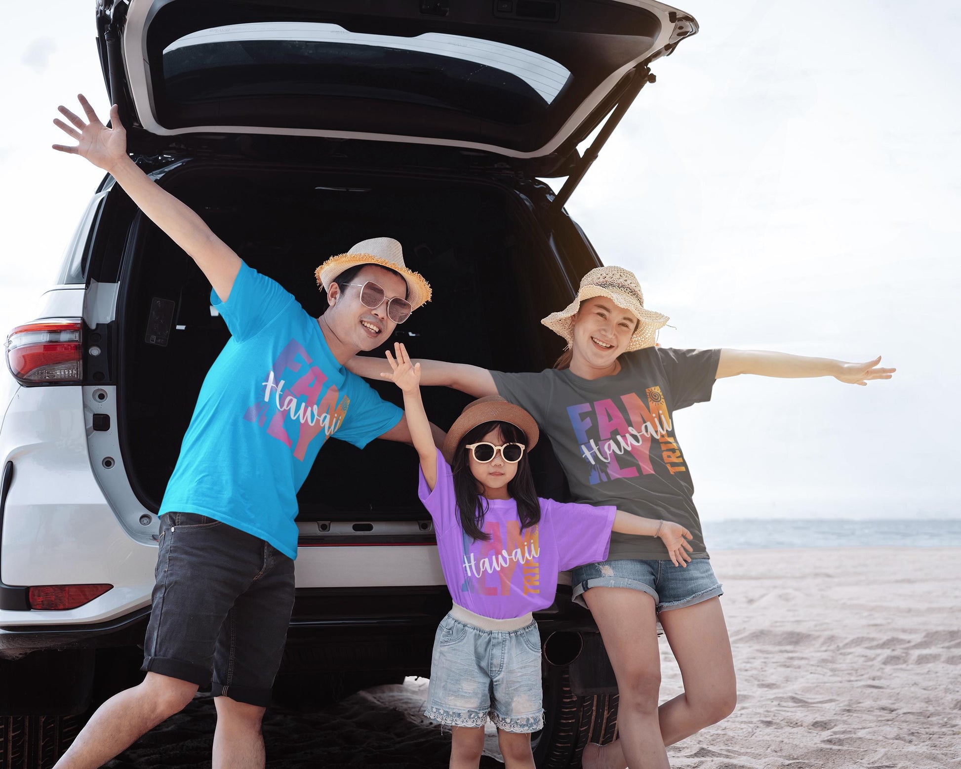 Fun family wearing matching Family trip shirts on the beach.