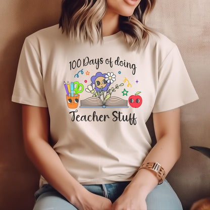 Woman sitting casually in a sand-colored 100 Days of Doing Teacher Stuff t-shirt, showcasing a playful design of classroom-themed icons, ideal for educators.