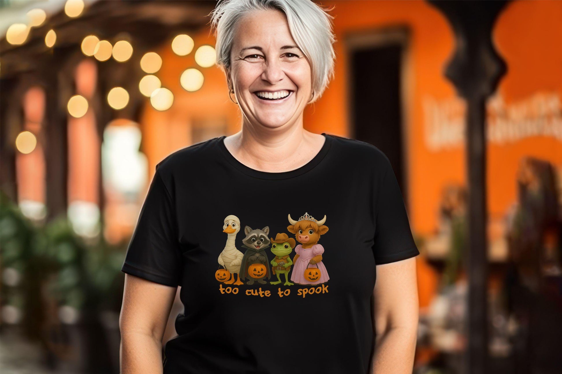 Black Halloween shirt with cute cartoon animals in costumes and &quot;Too Cute to Spook&quot; text.