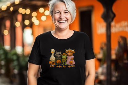 Black Halloween shirt with cute cartoon animals in costumes and &quot;Too Cute to Spook&quot; text.