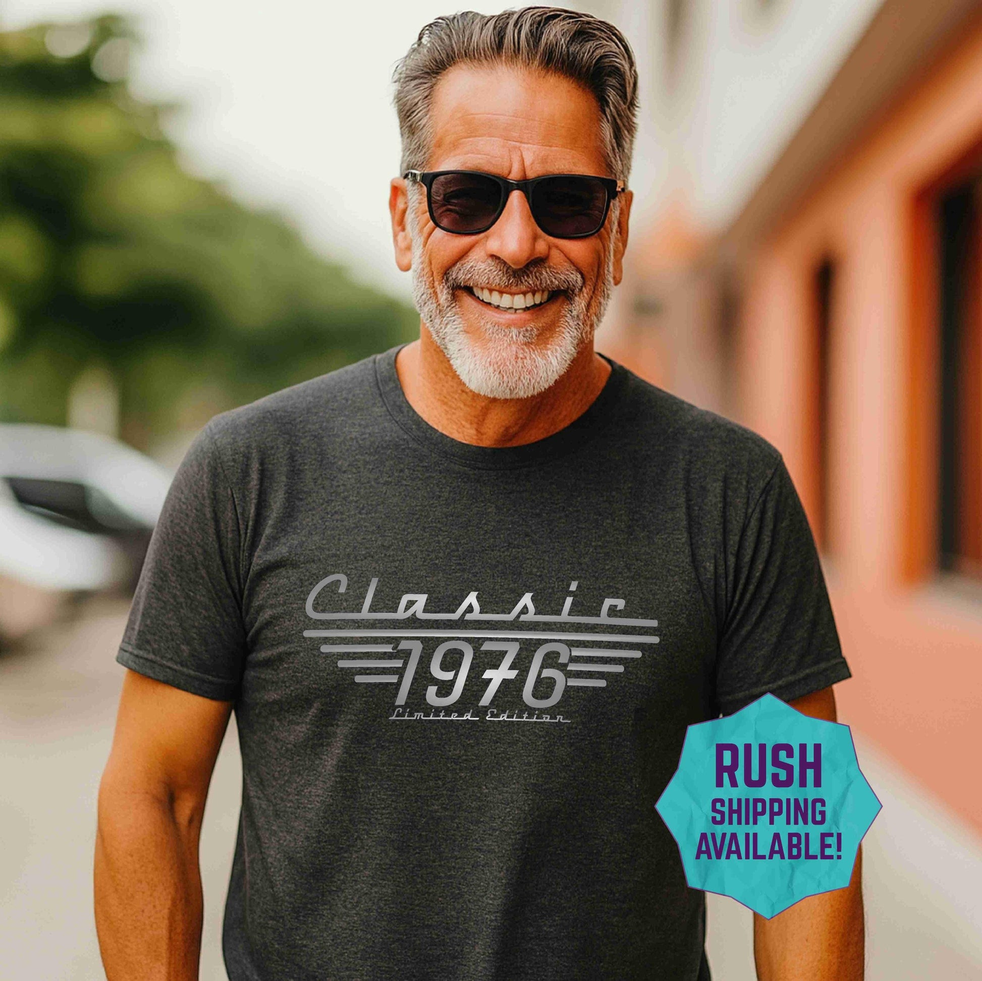 Man wearing a black t shirt with Classic 1976, Limited Edition printed in greys.  50th Birthday Shirt for men