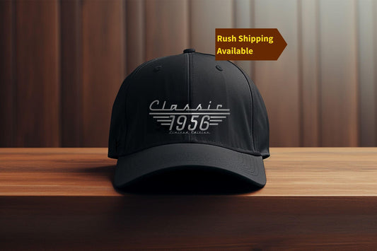 Black Classic 1956 Limited Edition baseball cap displayed on a wood table against a wood panel wall.