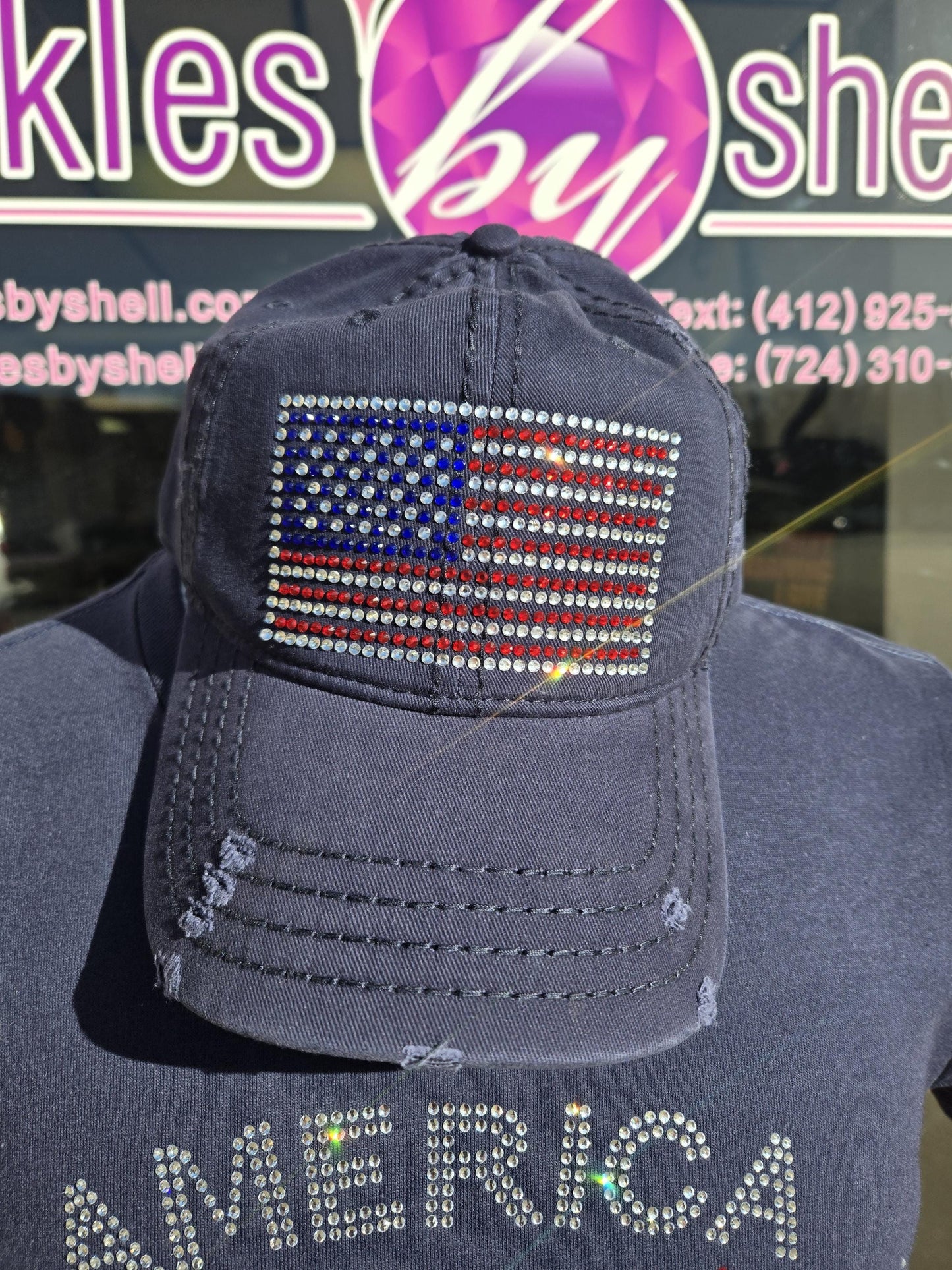 Navy blue distressed velcro back trucker had with a rhinestone American Flag on the front.