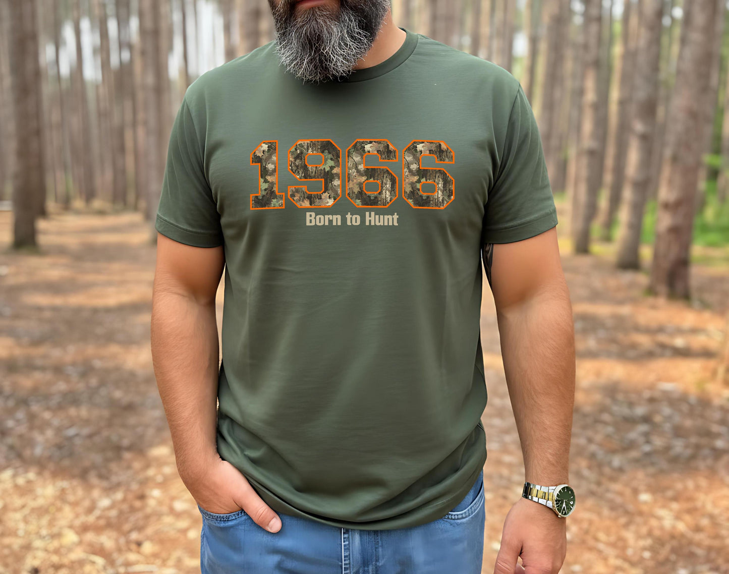 Man with grey beard wearing a 1966 Born to Hunt t-shirt with orange-outlined camouflage numbers in a pine forest. Perfect for the hunter who is turning 60 year old.