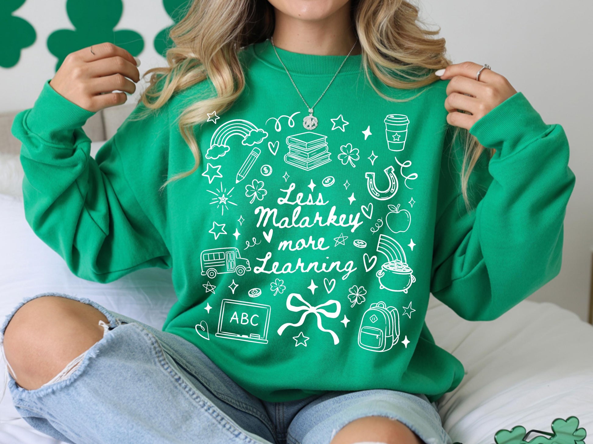 St Patricks Day teacher sweatshirt with less malarkey more learning doodle art and school supplies.