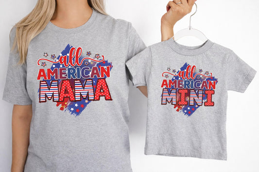 Woman and child wearing matching grey All American Mama and Mini t-shirts with red white and blue patriotic graphics.