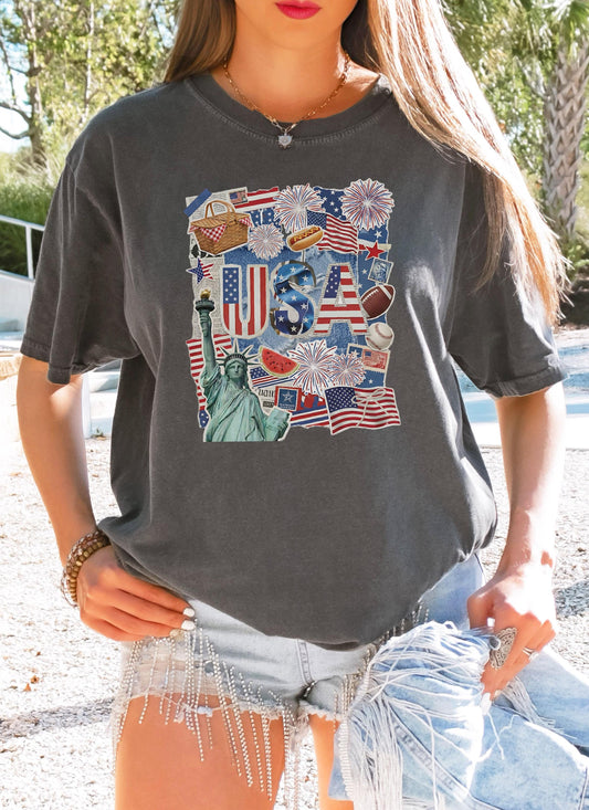 Woman wearing a patriotic USA ransom letter collage t-shirt with fireworks, flags, and the Statue of Liberty.
