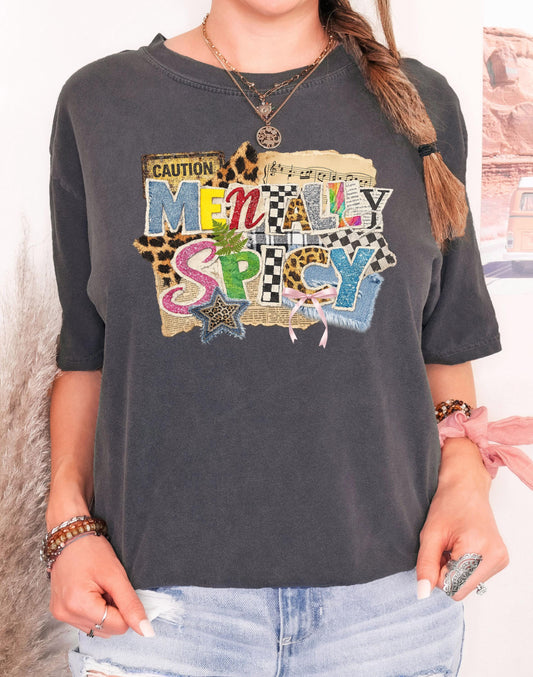 Model wearing a Comfort Colors Pepper t-shirt with a "Mentally Spicy" ransom note style collage graphic and pink bow.