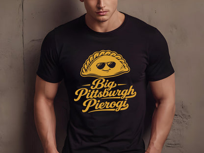 Man wearing a black comfortable t-shirt featuring a cute cartoon pierogi with sunglasses and text reading Big Pittsburgh Pierogi.