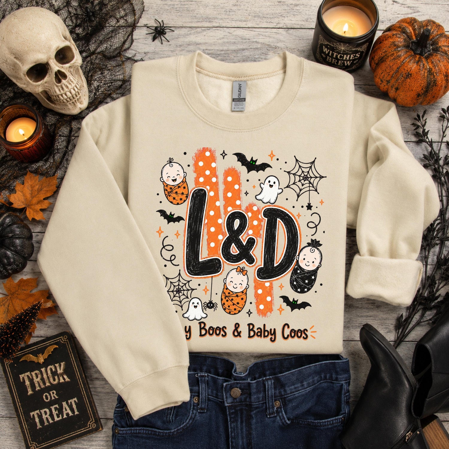 Sand-colored Gildan sweatshirt with L&D Halloween design: babies, ghosts, bats, "Tiny Boos & Baby Coos" text
